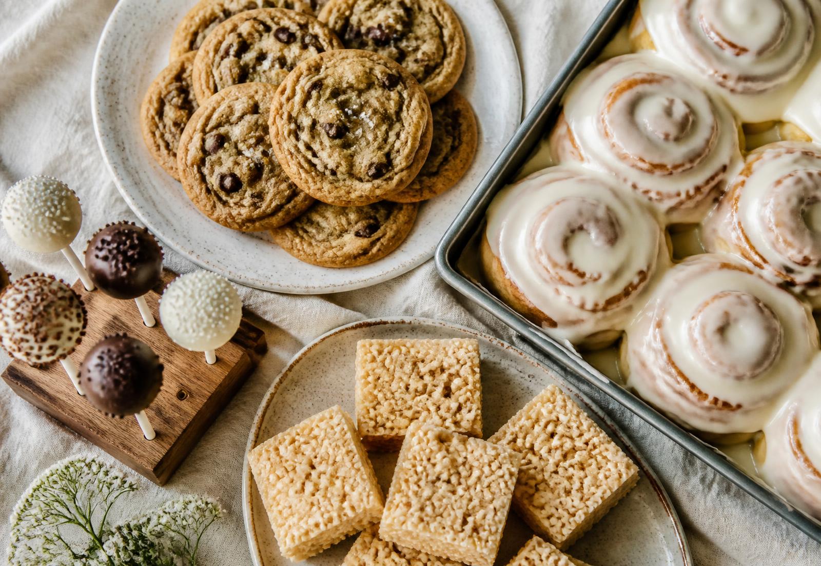 Cookies, cinnamon rolls and other homemade treats on a farmhouse table
